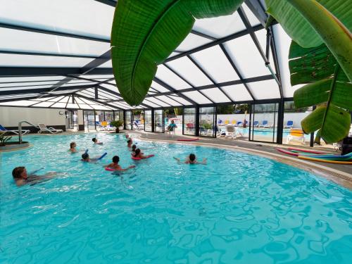 a group of people swimming in a swimming pool at Lebraz 2 in Saint-Lunaire