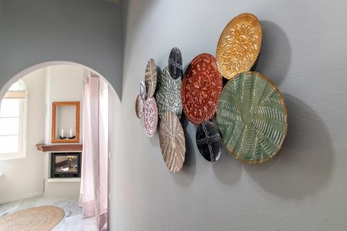 a group of plates hanging on a wall at Θἔρως (Theros) house 3- Agios Fokas in Agios Sostis