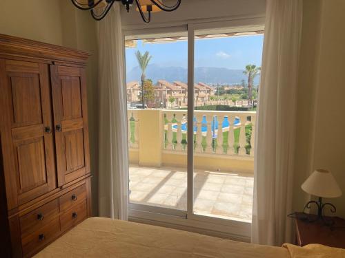 a bedroom with a large window with a view of a balcony at Playa Sol Denia Mediterranea-Serviden in Denia