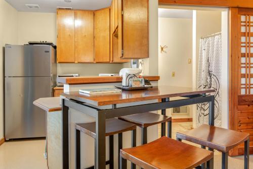a kitchen with wooden cabinets and a kitchen island with stools at Octopus Den in Coupeville
