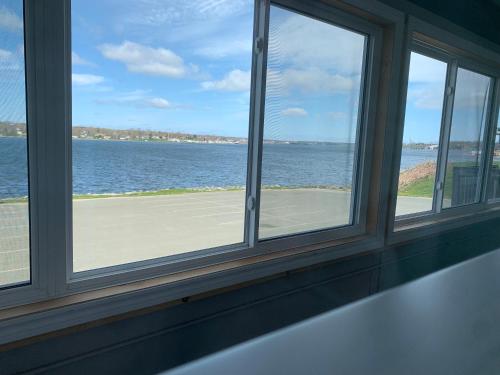 a window with a view of the ocean at Harbourview Inn and Suites in Sydney