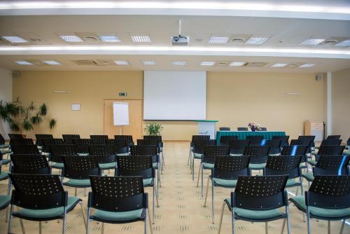 a large room with chairs and a screen in it at Park Hotel Latgola in Daugavpils