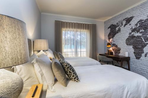 a bedroom with two beds and a brick wall at Penthouse Duplex Rooftop Jacuzzi 4 Rooms 6 beds 8 Persons in Cascais
