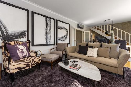 a living room with a couch and a surfboard in it at Penthouse Duplex Rooftop Jacuzzi 4 Rooms 6 beds 8 Persons in Cascais