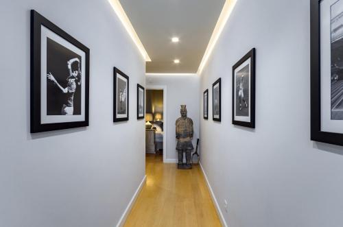 a hallway with black and white pictures on the walls at Penthouse Duplex Rooftop Jacuzzi 4 Rooms 6 beds 8 Persons in Cascais