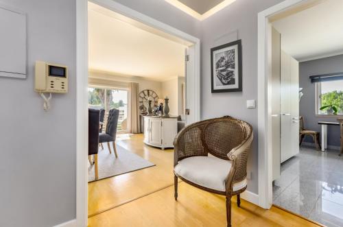 a living room with a chair and a table at Penthouse Duplex Rooftop Jacuzzi 4 Rooms 6 beds 8 Persons in Cascais
