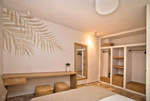 a bedroom with a bed and a mirror at Horizon Hotel Kalymnos in Myrties