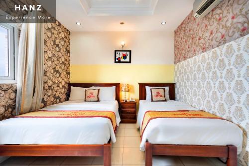 Giường trong phòng chung tại HANZ Vuong Quang Hotel