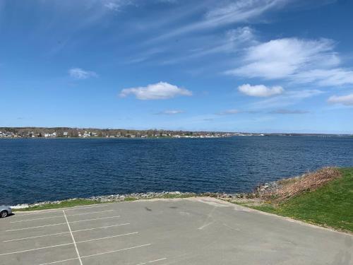 a parking lot next to a large body of water at Harbourview Inn and Suites in Sydney