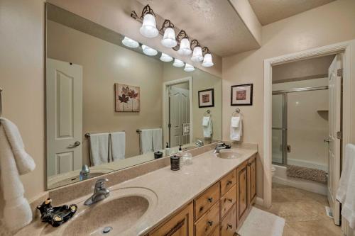 a bathroom with two sinks and a large mirror at High-End Huntsville Condo with Private Hot Tub! in Huntsville