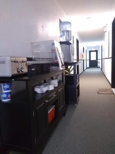 a hallway of an office with a desk and a kitchen at The Orca Inn in Friday Harbor