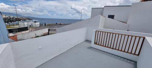 a white balcony with a view of the ocean at Sea House - Santa Clara in Ponta Delgada
