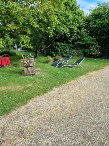 a couple of lawn chairs sitting in the grass at Chambre Chagall - Closeries du Golfe in Theix