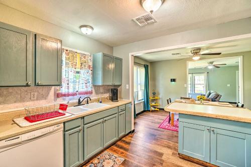 a large kitchen with blue cabinets and a sink at Centrally Located Lawton Home Dogs Welcome! in Lawton