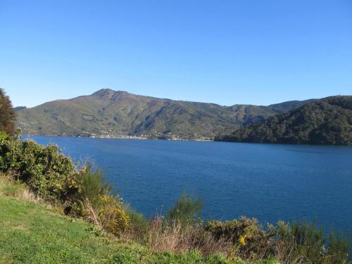 a large body of water with mountains in the background at Anakiwa 401 in Anakiwa