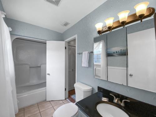 a bathroom with a sink and a toilet and a mirror at Highview Sunseekers 7 Condo in Santa Rosa Beach