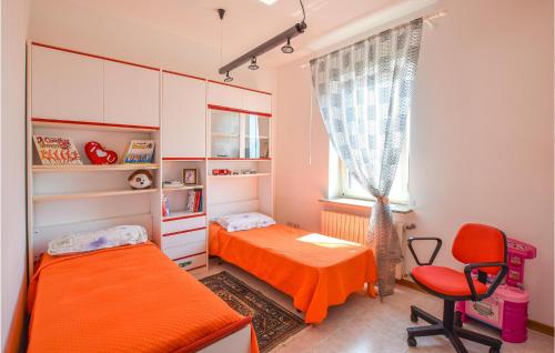 a small bedroom with two beds and a window at 2 Bedroom Cozy Apartment In Grado in Grado