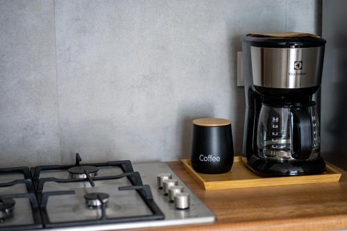 a coffee maker sitting on a counter next to a stove at Apartament Willa Lniana in Sulechów