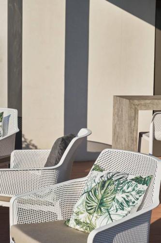 a room with chairs and a table with a pillow at 7Rizes Luxury Living in Heraklio Town