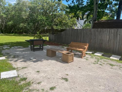 a picnic table and a bench in a backyard at Mar Bay Exclusive Suites in Safety Harbor