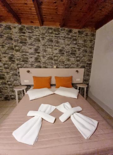 łóżko z dwoma białymi ręcznikami na górze w obiekcie Loutro Holidays w mieście Loutro