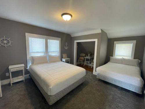 a bedroom with two beds with white pillows at 3 Bedroom House with Lake Pepin views with access to shared pool in Lake City