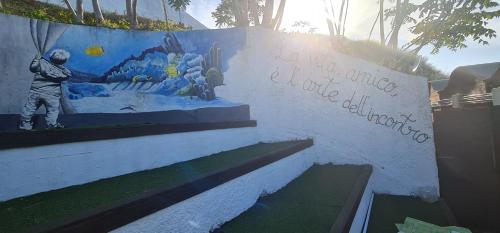 a wall with a painting of a man on it at B&B Aria di Mare - Pollina Sicilia in Finale