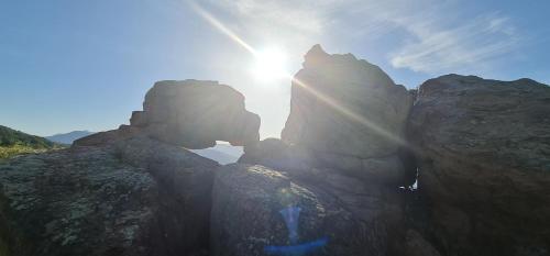 a person standing on top of a rock formation at B&B Aria di Mare - Pollina Sicilia in Finale