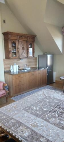 a kitchen with a sink and a refrigerator at Hortensjowe Wzgórze in Myślenice