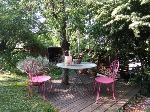 a table and four chairs on a wooden deck at Meublés Les Charmettes in Chambéry