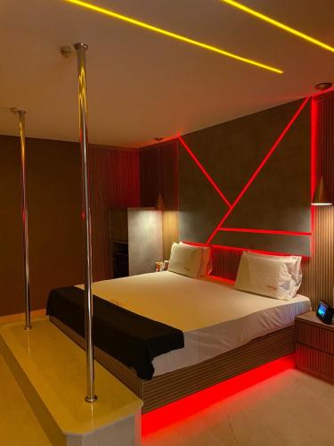 a bedroom with a large bed with red lighting at Motel Exótico Prime - Próximo GRU Aeroporto in Itaquaquecetuba