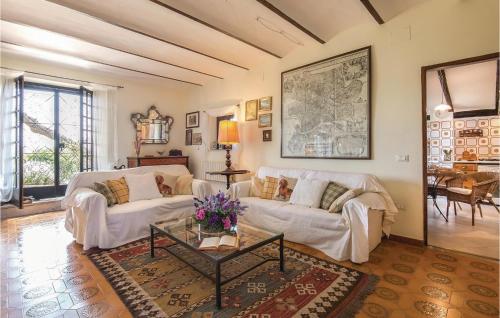 a living room with two white couches and a table at Il Seminario in Collevecchio