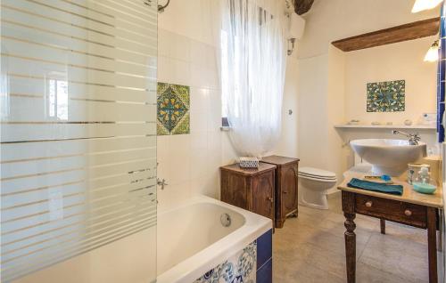 a bathroom with a tub and a toilet and a sink at Il Seminario in Collevecchio