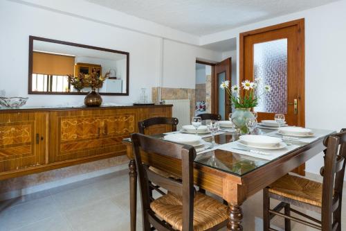 a dining room with a table and chairs and a mirror at Kiki's House near Falassarna and Balos in Plátanos