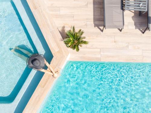 an overhead view of a swimming pool with a pool noodle istg at Le Confidentiel Hôtel & SPA in Saint-Raphaël