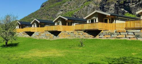 a row of houses on top of a stone wall at Lunde Camping in Aurland
