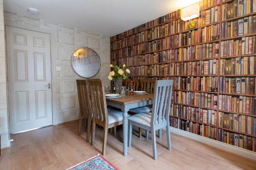 a dining room with a table and a large library at 3 Bedroom House - a very British place to stay - near city centre ! in Oxford