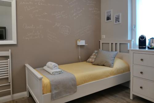 a childs bedroom with a bed and a chalkboard wall at Vicolo Fiore Affittacamere II in Matera