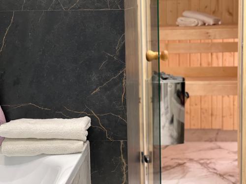 a bathroom with a glass shower with towels on a counter at Family & Business Sauna Tężnia Apartments No 20 Leśny nad Zalewem Cedzyna - 1 Bedroom with Private Sauna, Bath with Hydromassage , Terrace, Parking, Catering Options in Kielce