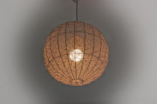 a pendant light hanging from a ceiling at Le gîte de la glycine in Palmas
