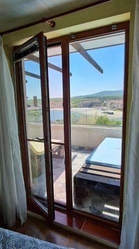 a room with a window with a view of the ocean at Magic Sea View in Tsarevo