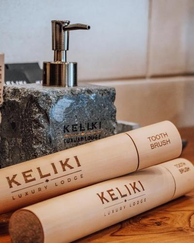 two bamboo toothbrushes sitting on a counter next to a sink at Keliki Luxury Lodge in Ubud