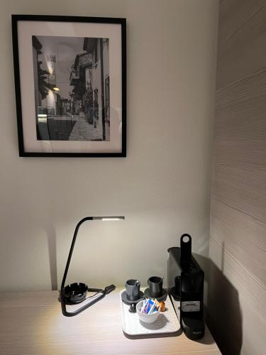a table with a lamp and a plate of food on it at Hotel Riva e Mare in Rimini