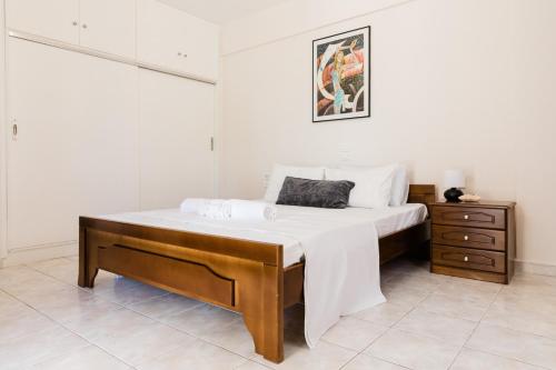 a bedroom with a large bed and a dresser at Alexandros Luxury Apartments Nydri in Nydri