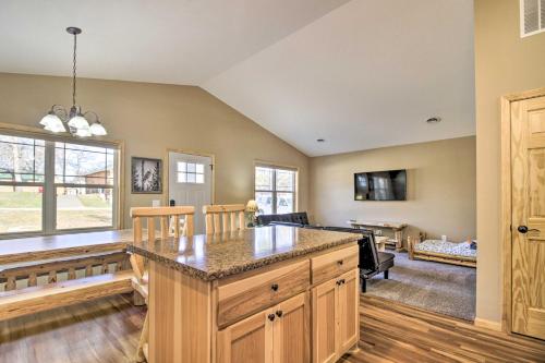 a kitchen with a large island in a room at Breezy Point Cabin with Fire Pit - Walk to Lake in Breezy Point