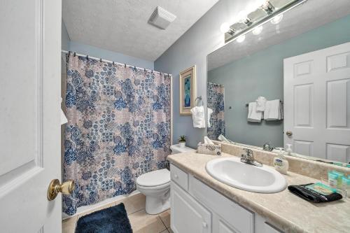 a bathroom with a sink and a toilet at PALM COVE VACATION HOME- One level, Community pool, Pet Friendly in Panama City Beach