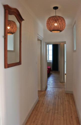 a hallway with a mirror on the wall and a room at Le gîte de la glycine in Palmas