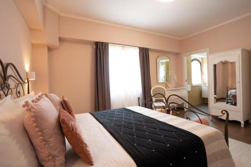 a bedroom with a bed and a dining room at Il Castellaccio in Spello