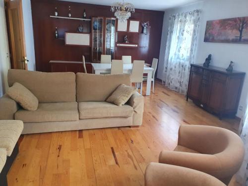 a living room with a couch and a dining room at Apartamento Marboré in Torla