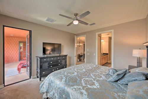 a bedroom with a bed and a dresser with a television at Naples Resort Townhome with Endless Amenities! in Lely Resort